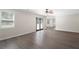 Open-concept living room featuring hardwood floors, neutral walls, and sliding doors to the backyard at 3729 Meadow Glen Cir, Ellenwood, GA 30294