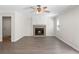 Bright living room features a fireplace, ceiling fan, and hardwood floors at 3729 Meadow Glen Cir, Ellenwood, GA 30294