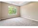 Carpeted bedroom featuring a large window with backyard views at 4783 Creekside Pl, Decatur, GA 30035
