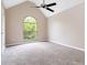 Carpeted bedroom with vaulted ceiling and arched window at 4783 Creekside Pl, Decatur, GA 30035