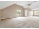 Large bonus room with vaulted ceiling and dual windows providing natural light at 4783 Creekside Pl, Decatur, GA 30035