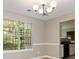 Bright dining room with a chandelier and view into the kitchen at 4783 Creekside Pl, Decatur, GA 30035