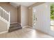 Bright foyer with hardwood floors, a white door with glass, and staircase at 4783 Creekside Pl, Decatur, GA 30035