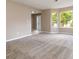 Bright living room featuring neutral paint, large windows, and plush carpeting at 4783 Creekside Pl, Decatur, GA 30035
