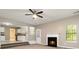 Open-concept living room with a fireplace and view into the kitchen at 4783 Creekside Pl, Decatur, GA 30035