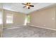 Spacious main bedroom featuring plush carpeting, and tray ceiling with fan at 4783 Creekside Pl, Decatur, GA 30035