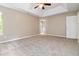 Main bedroom with plush carpet, tray ceiling, and ensuite access at 4783 Creekside Pl, Decatur, GA 30035