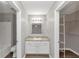Bathroom with a single vanity, shower/tub combo, and walk-in closet at 5514 E Stoneway Ct, Villa Rica, GA 30180