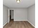 Empty bedroom with wood-look flooring, gray walls and bright lighting at 5514 E Stoneway Ct, Villa Rica, GA 30180