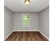 Bedroom featuring wood floors and window at 5514 E Stoneway Ct, Villa Rica, GA 30180