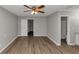 Empty bedroom with an ensuite bathroom and walk-in closet; has wood-look flooring and ceiling fan at 5514 E Stoneway Ct, Villa Rica, GA 30180