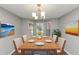 Dining room with bay window, table with chairs, and decorative wall art at 5514 E Stoneway Ct, Villa Rica, GA 30180