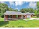 Charming brick home with a well-maintained lawn and a inviting front porch at 5514 E Stoneway Ct, Villa Rica, GA 30180