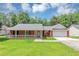 Charming one-story brick home with a welcoming front porch and lush green lawn at 5514 E Stoneway Ct, Villa Rica, GA 30180