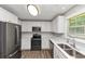 Modern kitchen featuring stainless steel appliances, white countertops, and hardwood flooring at 5514 E Stoneway Ct, Villa Rica, GA 30180