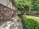 Back porch next to landscaped area and air conditioning units, blending outdoor living with practical utilities at 1175 Church St # B, Decatur, GA 30030