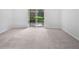 Spacious living room features neutral carpeting and access to the outdoors through sliding glass doors at 1175 Church St # B, Decatur, GA 30030