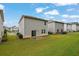 A view of the backyard showcasing the grassy lawn and surrounding residential neighborhood at 1998 Nuthatch Dr, Hoschton, GA 30548