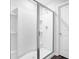 This bathroom features a glass shower, white tile, and a chrome shower head at 1998 Nuthatch Dr, Hoschton, GA 30548