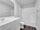 Clean bathroom with white vanity, sink, toilet, and shower-tub combination at 1998 Nuthatch Dr, Hoschton, GA 30548