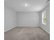 This bedroom features plush carpet, neutral walls, and a window with blinds for natural light at 1998 Nuthatch Dr, Hoschton, GA 30548