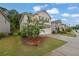 View of a two-story home, featuring a brick facade, two-car garage, and landscaped front yard at 1998 Nuthatch Dr, Hoschton, GA 30548