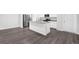 Kitchen featuring an island, granite countertops, stainless steel appliances, and dark wood floors at 1998 Nuthatch Dr, Hoschton, GA 30548