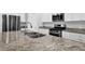 Modern kitchen showcasing granite countertops, stainless steel appliances, and ample cabinet space at 1998 Nuthatch Dr, Hoschton, GA 30548
