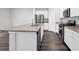 Kitchen island with stainless steel appliances, granite countertops, and white cabinets at 1998 Nuthatch Dr, Hoschton, GA 30548