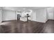 Spacious open-concept living area with dark floors, white cabinets, an island, and modern appliances at 1998 Nuthatch Dr, Hoschton, GA 30548