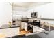 Modern kitchen featuring stainless steel appliances, white cabinets, and dark countertops at 220 Renaissance Ne Pkwy # 1105, Atlanta, GA 30308