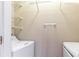 Laundry closet with shelving and side-by-side white washer and dryer at 220 Renaissance Ne Pkwy # 1105, Atlanta, GA 30308