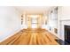 Spacious living room featuring hardwood floors, columns, and an open floor plan at 220 Renaissance Ne Pkwy # 1105, Atlanta, GA 30308