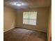 A carpeted bedroom featuring neutral walls, double windows, and a ceiling light at 2850 Cedar Trace Dr, Ellenwood, GA 30294