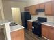 Functional kitchen featuring black appliances, ample counter space, and wood cabinets at 2850 Cedar Trace Dr, Ellenwood, GA 30294