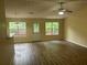 Bright living room with hardwood floors, ceiling fan, and natural light from windows overlooking the backyard deck at 2850 Cedar Trace Dr, Ellenwood, GA 30294