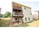 A two-story home with a two level back porch and a backyard with green grass at 3020 Whitfield Ave, Cumming, GA 30040