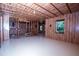 Large unfinished basement with wood ceilings, wood paneling, and window to outdoors at 3020 Whitfield Ave, Cumming, GA 30040