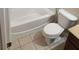 This cozy bathroom features cream tile flooring, a white toilet and tub at 3020 Whitfield Ave, Cumming, GA 30040