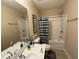 Charming bathroom featuring double sinks and a shower over tub with colorful curtain at 3020 Whitfield Ave, Cumming, GA 30040