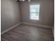 Bedroom featuring hardwood-style floors and natural light at 3020 Whitfield Ave, Cumming, GA 30040