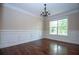 Dining room with hardwood flooring, elegant wainscoting, and a stylish chandelier at 3020 Whitfield Ave, Cumming, GA 30040