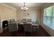 Formal dining room featuring a large table, stylish chandelier, and neutral color palette at 3020 Whitfield Ave, Cumming, GA 30040