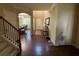 Inviting entryway featuring hardwood floors, an arched doorway, and a clear view of the dining room at 3020 Whitfield Ave, Cumming, GA 30040