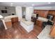 Spacious kitchen featuring an island, granite countertops, stainless steel appliances, and wooden flooring at 3020 Whitfield Ave, Cumming, GA 30040