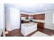 Beautiful kitchen with stainless appliances, island with granite countertop, and dark wood cabinets at 3020 Whitfield Ave, Cumming, GA 30040
