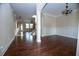 Open-concept living room featuring hardwood floors, elegant lighting, and classic trim at 3020 Whitfield Ave, Cumming, GA 30040