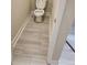 Small powder room with wood-look tile flooring at 3020 Whitfield Ave, Cumming, GA 30040