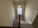 Bright staircase landing featuring modern lighting and light wood flooring at 3020 Whitfield Ave, Cumming, GA 30040