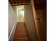 Carpeted staircase leading upstairs is illuminated by a small light fixture at 3020 Whitfield Ave, Cumming, GA 30040